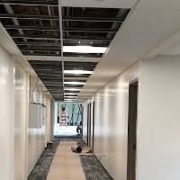 A hallway under construction, with flooring being put in.